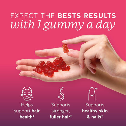 Hand holding biotin gummies with a one a day callout