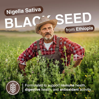Ethiopian farmer standing in a black seed field